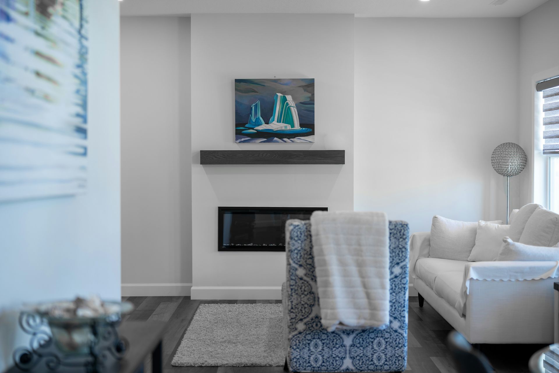 Modern living room with fireplace and abstract art.