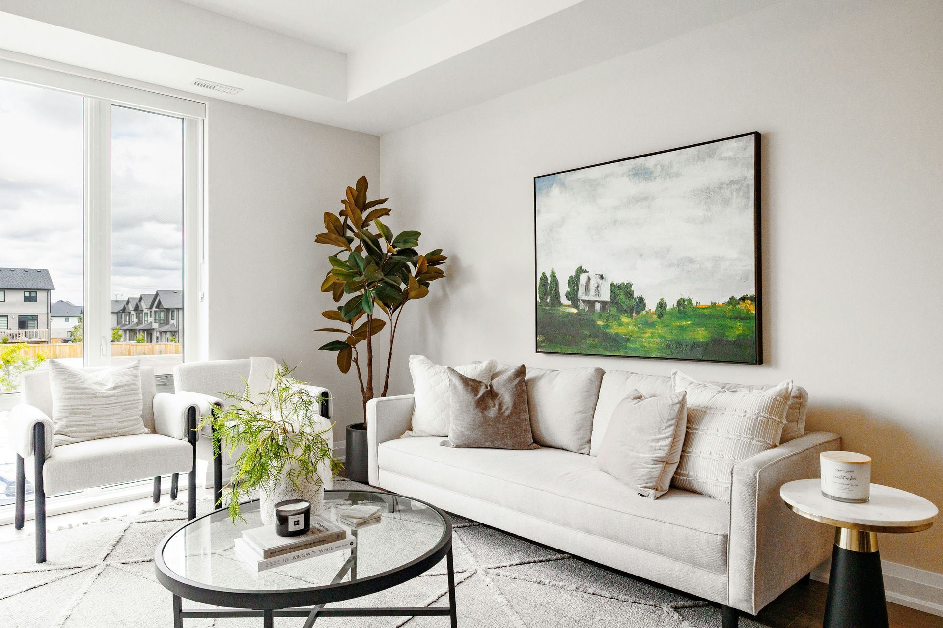 Modern living room with white sofa and artwork.